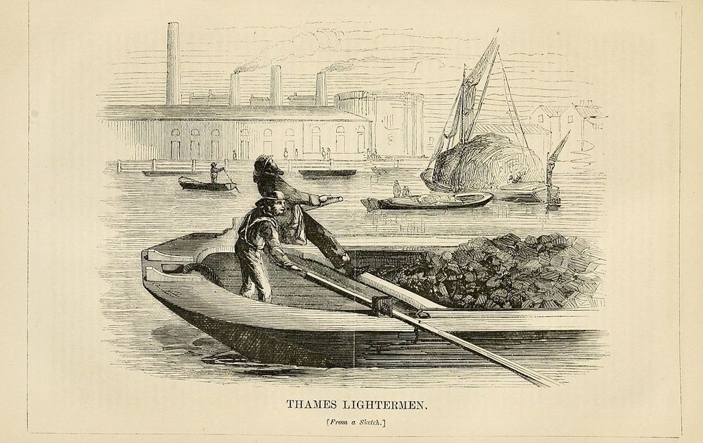 Two men row a barge across the thames in the foreground. In the background, ships pass, and industrial buildings can be seen on the bank. The lightermen are rowing cargo. Beneath the photo, a caption reads 'THAMES LIGHTERMEN, from a sketch'